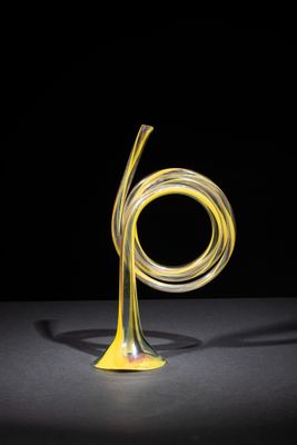 a close up of a glass sculpture on a table with a black background