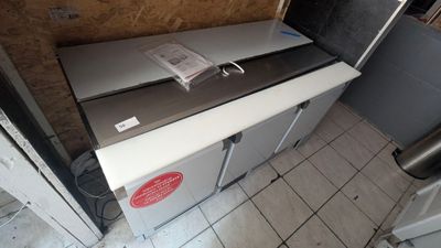 an image of a kitchen with a refrigerator and a sink