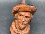 an image of a figurine of a man wearing a hat and holding a pipe