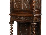an old wooden cabinet with carvings on the top of it