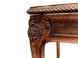 a wooden table with a carved top and legs