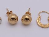 three pairs of gold earrings and a pair of gold earrings