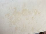a close up of a chair with a leather seat and back