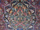 an image of a large oriental rug on display in a room