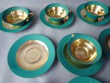 several tea cups and saucers are sitting on a table