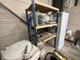 a white toilet sitting next to a white refrigerator in a room