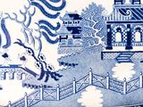 a blue and white plate with a dragon on it