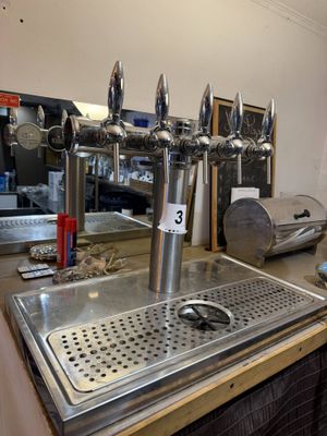a metal sink in the middle of a counter