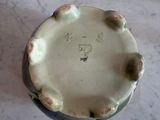 a close up of a ceramic bowl on a marble surface