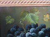 a picture of a painting of grapes and a butterfly