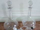 three glass bottles sitting on a marble counter top