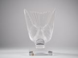 a clear glass vase with a bird head on it