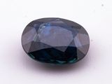 a close up of a blue diamond on a white surface
