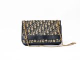 a black and gold purse with a chain strap