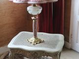 a table with a lamp on top of it in a room