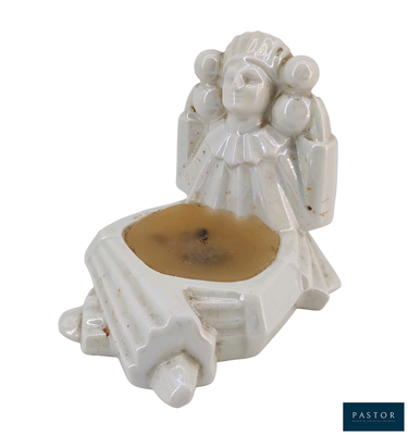 a figurine of an angel holding a cup of coffee