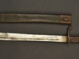two knives are sitting side by side on a table