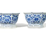 pair of blue and white vases with floral designs on stands