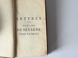 an old book with a clock on it sitting on a table