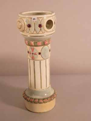 a white vase with a design on it on a table