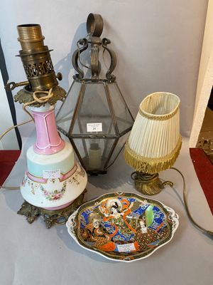 a table with a lamp, a plate, and a plate on it