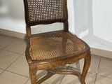 a wooden chair that is sitting on a tile floor