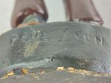 a close up of a statue of a person on a skateboard