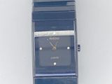 a blue watch that is sitting on a white surface