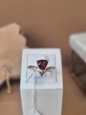a ring with a heart shaped garnet stone in it