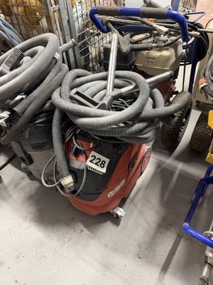 a pile of vacuums and other equipment on the floor