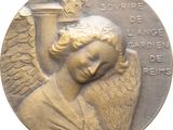 une image représentant une médaille de bronze sur laquelle figure un ange