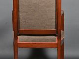 a wooden chair with a brown upholstered seat and arm rest
