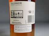a bottle of whiskey sitting on a table with a barcode label on it