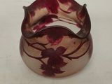 a close up of a glass bracelet with a flower design on it