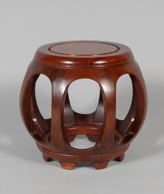 an image of a wooden stool with a circular design on the top