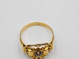 a gold ring with a small diamond on top of it