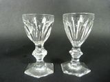 two clear glass goblets sitting on top of a black table