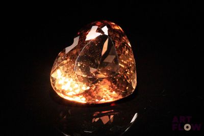 a close up of a diamond on a black surface