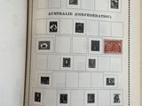 an open book with stamps on it on a table