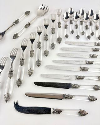 a lot of silver and silverware on the table