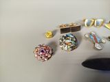 a pair of scissors and a pair of earrings on a table