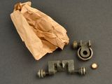 a brown paper bag and some metal fittings on a table