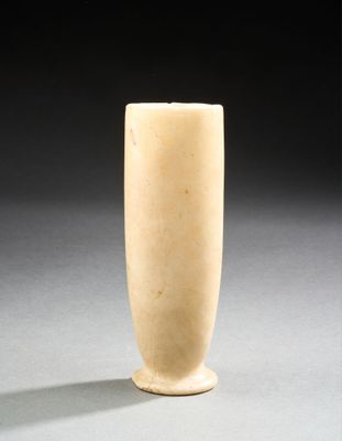 un vase blanc posé sur une table sur fond noir