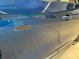 a close up of a car door with a sticker on it