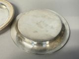 a silver plate with a silver lid and a silver plate with a silver lid