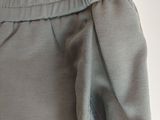 the back of a pair of pants with buttons on the side