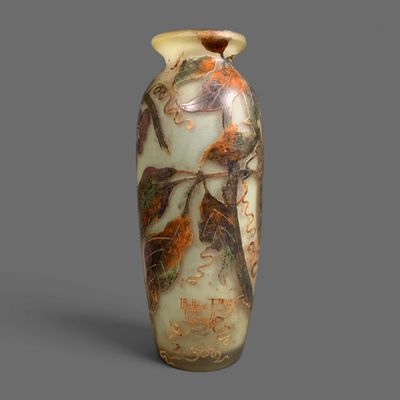 a vase with a design on it sitting on a table