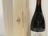 a bottle of wine sitting next to a wooden box
