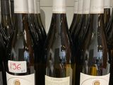 several bottles of wine are lined up on a counter