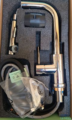 a box with a faucet and a hose in it